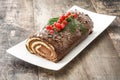 Chocolate yule log christmas cake with red currant Royalty Free Stock Photo