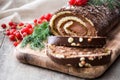 Chocolate yule log christmas cake with red currant