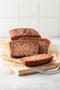 Chocolate zucchini bread cake sliced on white tile kitchen background Royalty Free Stock Photo