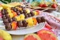 chocolatedipped tropical fruit kabobs displayed on a festive party table Royalty Free Stock Photo
