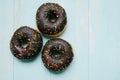 Chocolatel donuts on blue background. Top view with copy space Royalty Free Stock Photo