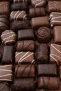 Chocolates assortment .Chocolate sweets.Chocolate pattern. Candy close-up on a brown background.dark milk chocolates