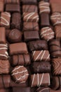 Chocolates assortment set.Chocolate sweets.Chocolate pattern. Candy close-up on a brown background.dark milk chocolates