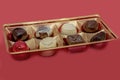 Chocolates in gold packaging on a red background