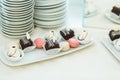 Chocolates and macaroons lie on the square plate Royalty Free Stock Photo