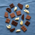 Chocolates and white chocolate curls arranged on a blue fabric Royalty Free Stock Photo