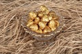 Chocolates wrapped in foil in luxury candy. Chocolate candies in a box in a gold wrapper Royalty Free Stock Photo