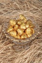 Chocolates wrapped in foil in luxury candy. Chocolate candies in a box in a gold wrapper Royalty Free Stock Photo