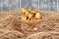 Chocolates wrapped in foil in luxury candy. Chocolate candies in a box in a gold wrapper Royalty Free Stock Photo