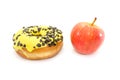 Choice between apple or junk food, donut. Diet and healthy food concept. Vegetarian, vegan, raw concepts. Apple and donut isolated Royalty Free Stock Photo