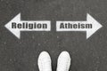 Choice between atheism and religion. Woman standing on road near arrows marking, top view