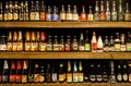 Choice of beer bottles on shelf with many sorts of lambic, lager, ales, strong stouts