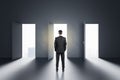 Choice concept with businessman in front of three opened doors Royalty Free Stock Photo