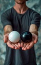 Choice concept, a man holding two spheres, one black and one white Royalty Free Stock Photo