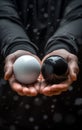 Choice concept, a man holding two spheres, one black and one white Royalty Free Stock Photo