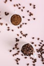 Choice between instant coffee and roasted coffee beans in cups on pink top and vertical view Royalty Free Stock Photo