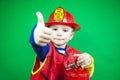 Choice of profession  little boy playing firefighter  children\'s firefighter costume Royalty Free Stock Photo