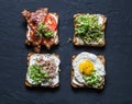 Choice of sandwiches for breakfast, snack, appetizers - avocado puree, fried egg, tomatoes, bacon, cream cheese, smoked mackerel g Royalty Free Stock Photo