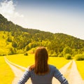 A choice of two ways. Woman at a crossroads Royalty Free Stock Photo