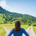 A choice of two ways. Woman at a crossroads Royalty Free Stock Photo