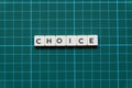 Choice word made of square letter word on green square mat background.