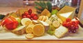 Choices of cheese variety with fruits and biscuits on a board Royalty Free Stock Photo