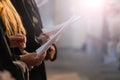 Choir singers holding musical score and singing on student gradu Royalty Free Stock Photo