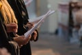 Choir singers holding musical score and singing on student graduation day in university, college diploma commencement Royalty Free Stock Photo