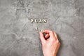 Choise plan a or plan b. The hand holds the letter B on a concrete background. Business strategy, failure analysis. Royalty Free Stock Photo