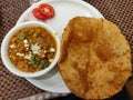 Chola bhatura. Famous Indian meal chik peas curry with flour fried poori or puri and salad.