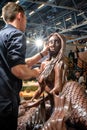 A cholatier fixing a chocolate mermaid sculpture a Salon du Chocolat