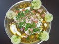 Chole aloo tikki with tangy and spicy chutneys and salad and curd