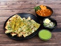 Chole Kulcha, Clay baked stuffed Naan served with channa masala or chole masala, typical meal of Amritsar, India. isolated over a