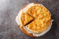 Cholera swiss leek, potato, apple and cheese pie closeup on the wooden board on the table. Horizontal top view