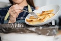 Cholesterol of junk meal is fat meal, hand of asian young household woman scraping, throwing food leftovers into garbage, trash Royalty Free Stock Photo