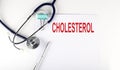 CHOLESTEROL text written on the paper with a stethoscope. Medical concept