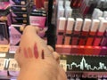 A girl test lips tester all color at Maybelline shelf store from supermarket in C