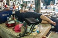 Sleeping female vendor on Nong Mon Market in Chon Buri, Thailand