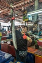 Woman shows long fish on Nong Mon Market in Chon Buri, Thailand