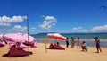 Many people sitting on sofa and taking picture with blue sky background at cafe or restaurant decorated with pink tone