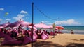 Many people sitting on sofa and taking picture with blue sky background at cafe or restaurant decorated with pink tone