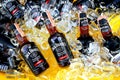 Many Cold Black whiskey mix with cola of Jack Daniel`s putting on ice in yellow tank for sale or party