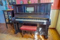 CHONCHI, CHILE, SEPTEMBER, 27, 2018: Indoor view of black piano inside of museum of chonchi filled with furniture and