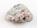 chondrodite in tumbled calcite stone on white