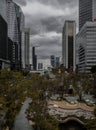 Chong Nonsi Canal Park. New park in city center surrounded green trees and stone courtyard in front of canal with skyscraper