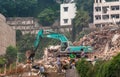 Demolition crew takes lunch breat on pile of rubble downtown Chongqing, China
