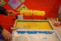 CHONGYUANG TEMPLE, CHINA: Delicious curly potato fries being prepared by chinese man at food market around temple area