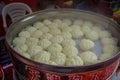 CHONGYUANG TEMPLE, CHINA: Small cakes of white raw dough, spread out in pot waiting to be deep fried, food market around