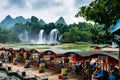 Chongzhuo, China - July 25, 2018: Tourist boats by the Detian Ban gioc waterfalls in China