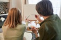 Girl creating a masterpiece at home near her granny Royalty Free Stock Photo